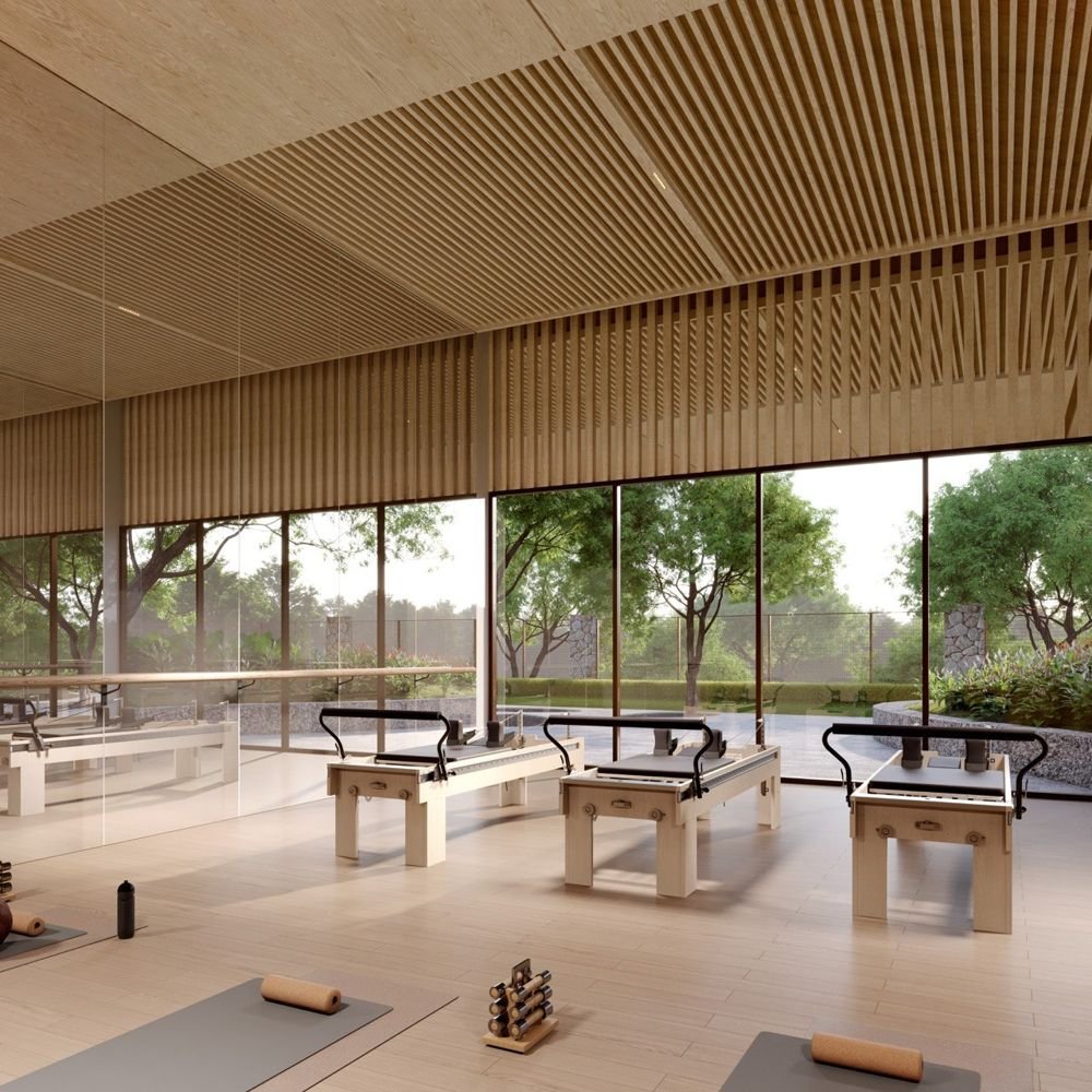 Studio with reformer machines and floor-to-ceiling glass